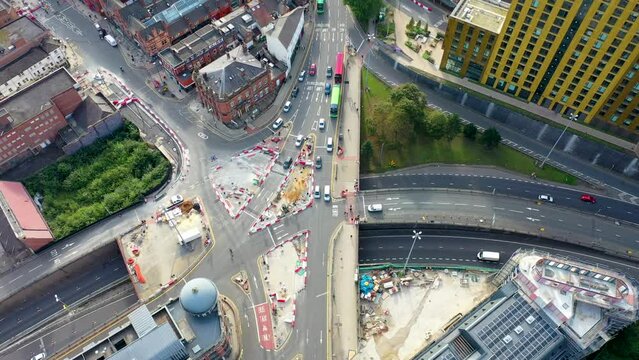 Top down aerial drone footage of the Leeds city centre in West Yorkshire in the UK, showing busy traffic and road works being done and the road known as York Road from above