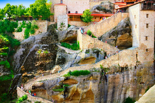 Huge scale to Great Meteoron Monastery (Megalo Meteoro) and walking tourists in Meteora, Kastraki, Greece. It is one of the most visited tourist place in Thessaly.