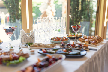 Wedding served banquet table with cold, hot appetizers. table with snacks, catering for a wedding. various snacks and drinks at the buffet table at the corporate catering event