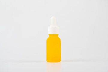 Yellow glass cosmetic bottle, Skin care or sunscreen cosmetic on white background.