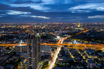 Crowded city with modern city and car traffic jams in high angle view. and the top of the bridge at a high angle See the blue horizon which is in Bangkok, Thailand