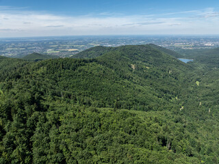 Obraz premium Drone fly above green mountains in summer. Polish green mountains and hills aerial drone photo. Drone view in Beskid mountains, Blatnia. Summer green forest on Blatnia. Beskid mountains in Jaworze.
