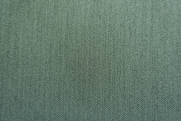 Macro of reseda green polyester fabric with herringbone pattern