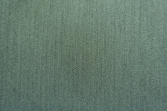 Macro of reseda green polyester fabric with herringbone pattern