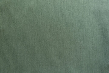 Texture of reseda green polyester fabric with herringbone pattern