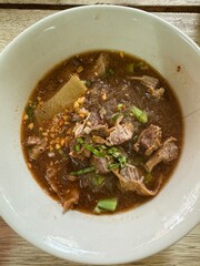 Vertical photo of Thai boat noodles, street local food in Thailand.