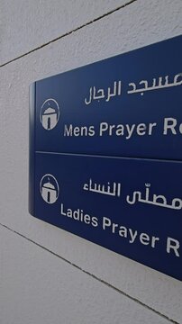Male and female prayer room signs displayed outside the rest area of a petrol station in the UAE