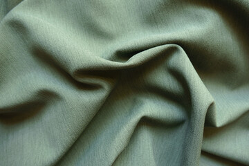 Jammed reseda green polyester fabric with herringbone pattern