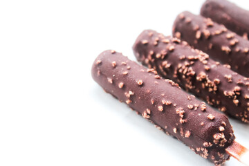 close up of several chocolate peanut flavored ice cream bars or popsicles ,isolated on white background