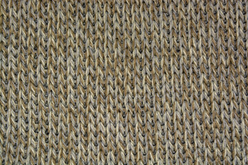 Knitted fabric made of multi-colored thread. Background texture of knitted fabric. Knitted fabric of blue, white, brown thread