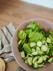 Chopped lettuce, cucumber and tomato in a bowl