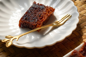 Kek Buah Kukus, a traditional Malaysian steamed fruit cake filled with dried fruits, nuts, and spices, enjoyed during celebrations.
