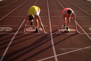 Two athletes at the stadium preparing for the start of the race