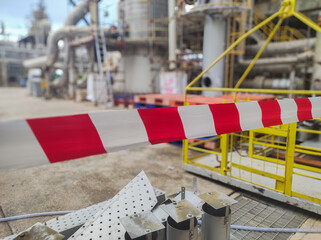Tap red white color warning barrier safety hazard caution stop line sign in industrial factory area