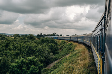 Fototapeta premium Travel to the mountains by train in summer. Beautiful scenery from the train window.