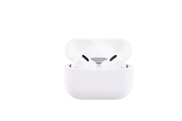 White wireless headphones in a storage and charging box. Transparent background. PNG