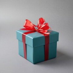 Obraz premium a blue gift box with a red ribbon and a green balloon on a gray background,