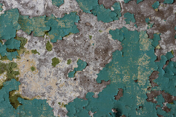 Peeling paint on the wall. Old concrete wall with cracked flaking paint. Weathered rough painted surface with patterns of cracks and peeling. Grunge texture for background and design. High resolution.
