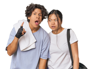 Young interracial athletic couple in studio having an idea, inspiration concept.