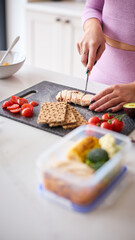 Close Up Of Woman Wearing Fitness Clothing At Home In Kitchen Making Healthy Meals For The Freezer