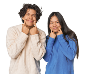 Young interracial couple in studio doubting between two options.