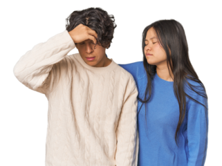 Young interracial couple in studio having a head ache, touching front of the face.