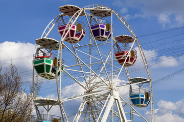 
colorful children's ferris wheel on blue sky