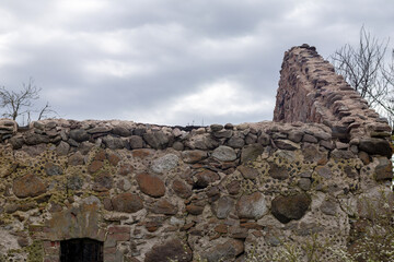 
the ruins of the wall of the old boulder building