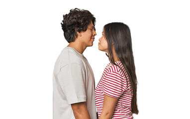 Fototapeta premium Multiracial couple in love gazing at each other in studio