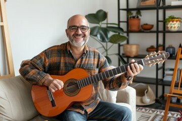 Obraz premium Portrait of a joyful man in his 50s playing the guitar on crisp minimalistic living room