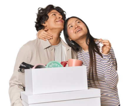 Multiracial young couple with moving boxes in studio