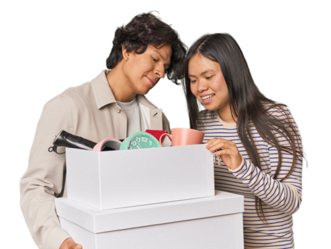 Multiracial young couple with moving boxes in studio
