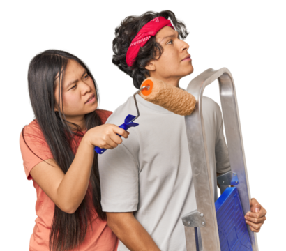 Multiracial couple ready to paint their new home in studio