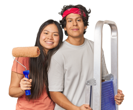 Multiracial couple ready to paint their new home in studio - Powered by Adobe