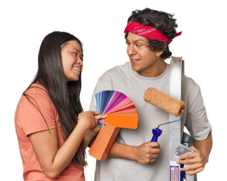 Happy multiracial couple with painting tools in studio
