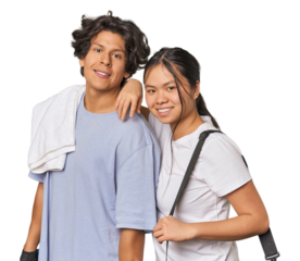 Multiracial athletic couple lifting weights in studio