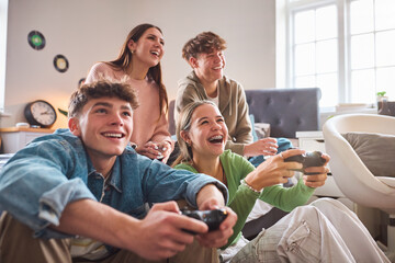 Close Up Of Teenage Girls And Boys At Home In Bedroom Together Playing Computer Games Together