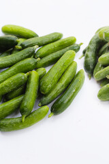 Mini cucumbers on white background.