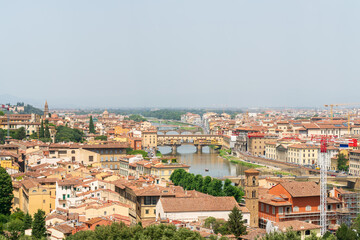 Florence, Italy. Ponte Vecchio. Medieval arched bridge with souvenir shops. Arno River. Panorama of the city. Summer day