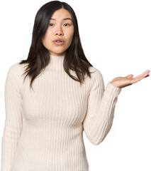 Young Chinese woman impressed holding copy space on palm.