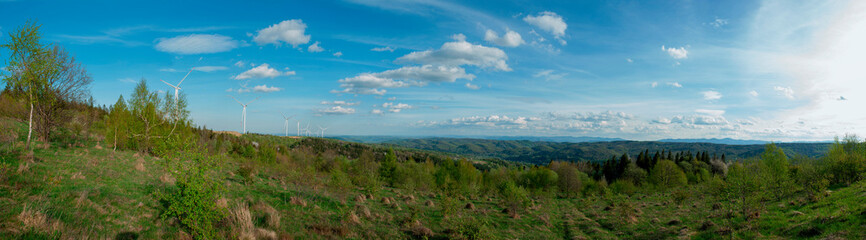 Wind turbine for alternative energy in mountain landscape with clear space background. The concept of clean energy, eco-energetics of the wind.