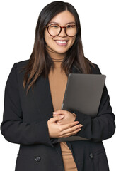 Confident Chinese businesswoman with laptop in studio