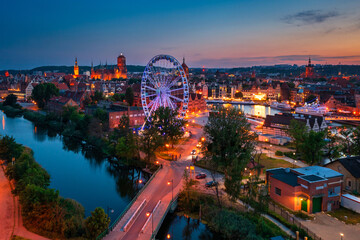 The Main Town of Gdansk with illuminated ferris wheel at sunset, Poland.