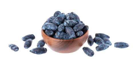 Honeysuckle in wooden bowl, isolated on white background. Fresh honeysuckle blue berry fruits. Clipping path. © vandycandy