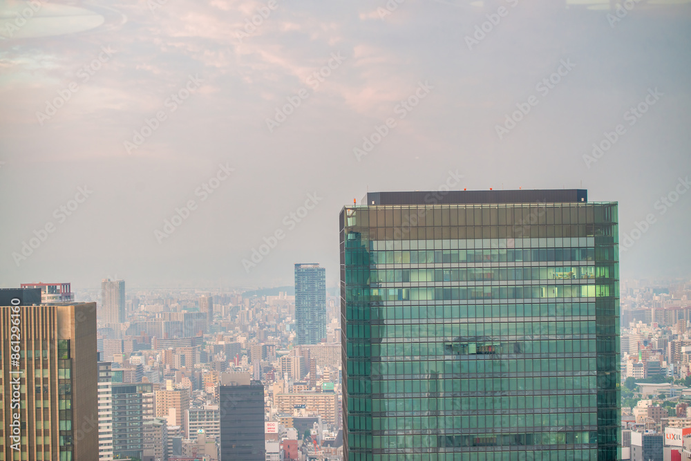 Sticker Osaka, Japan - May 28, 2016: Aerial view of city skyscrapers at sunset