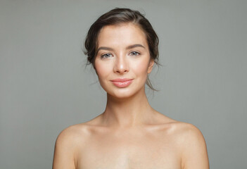 Fototapeta premium Fresh healthy model woman with beautiful skin and cute smile on white background, studio portrait. Facial treatment, skin care and cosmetology concept