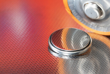 Flat lithium button cell and alkaline batteries close-up