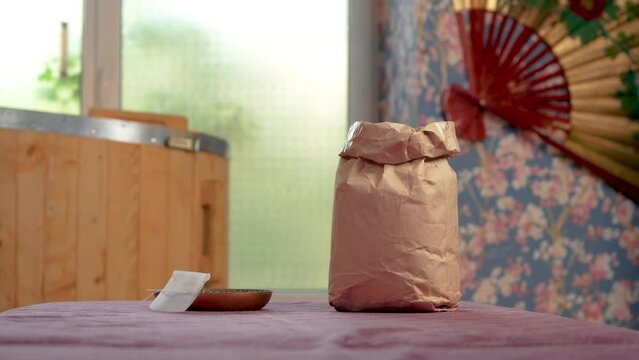 Paper bag with dry medicinal herbs for use in spa treatments sauna and herbal medicine phyto barrel for medical positive effect on human body. Cosmetic care, rejuvenation, skin lifting, excellent well