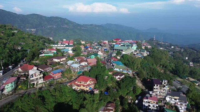 Disorderly housing community in the rugged terrain of a mountainous city. Drone aerial tracking shot
