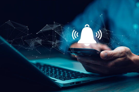 Business Hand hold smartphone and press the button of Notification bell button on smartphone app screen close up,App Notification on Smart Phone Screen, Remote online alerts, home security signal.